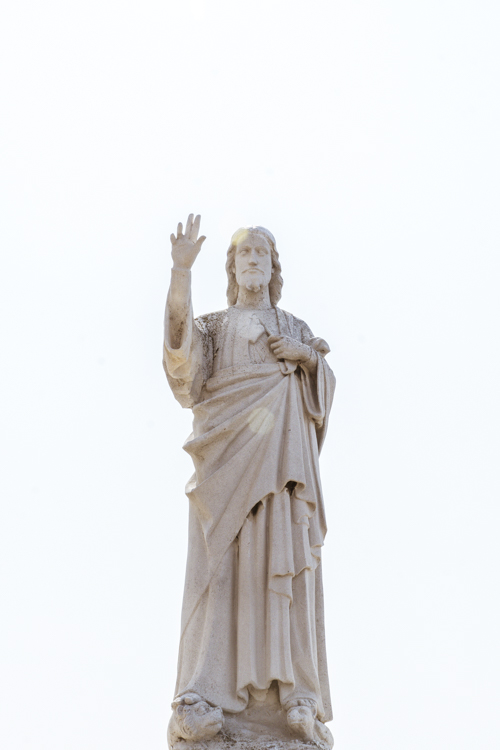 La statue du Christ photographi�e en contre plong�e sous un ciel blanc immacul�